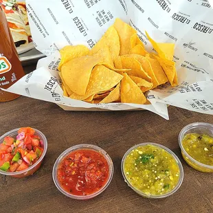 Chips and salsas. Salsas (left to right): Pico De Gallo, Tomate Rojo, Tomatillo Verde, and Jalapeños Asados.