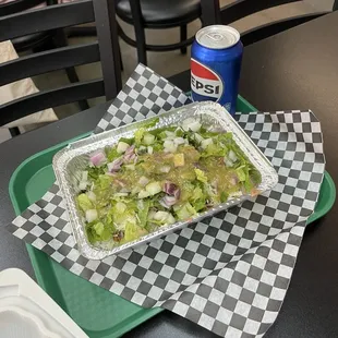 Bowl with steak, white rice, lettuce, onion, salsa verde