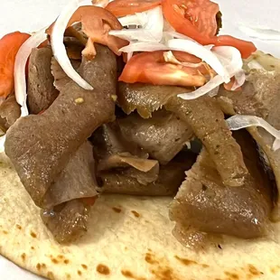beef and onions on a tortilla