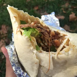 Spicy beef burrito - lettuce/cheese/rice/pinto beans/green tomatillo/red tomatillo.