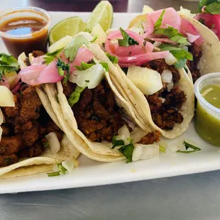 Al pastor tacos: Pickle red onions, pineapple, cilantro onions, hot &amp; mild sauce, limes