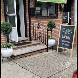 a sidewalk in front of a restaurant