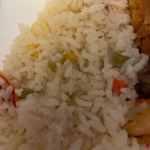 a plate of rice with meat and vegetables