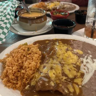 Lunch portion of cheese enchiladas and queso.