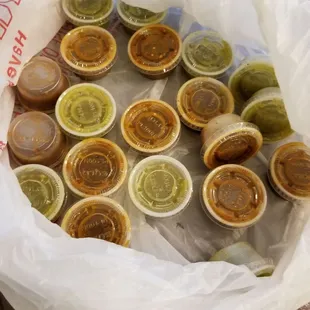 A whole bag of sauces. The red one is spicy!