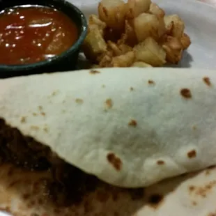 Barbacoa taco with salsa and substituted beans for potatoes