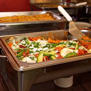 a variety of food in a buffet