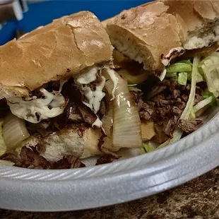 a sandwich on a paper plate