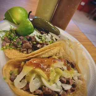 two tacos on a paper plate