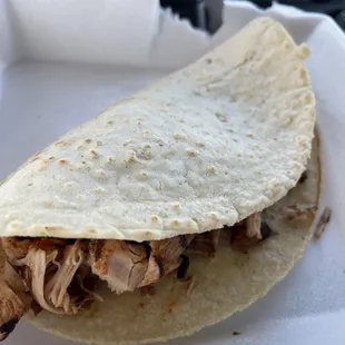 a chicken taco in a styrofoam container