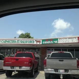 two trucks parked in front of a restaurant