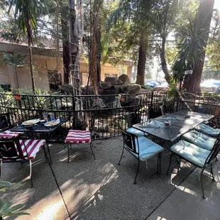 Outdoor patio, pond &amp; waterfall behind railing.