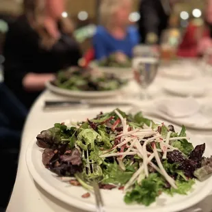 Mixed green salad has slivered pears, nuts, craisens, and a vinaigrette. Very good salad. And large