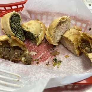 Empanadas - sliced in half to show filling. Spinach, chicken and beef.
