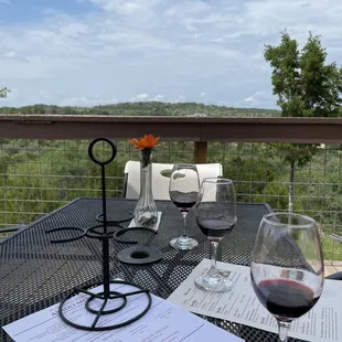 a table with wine glasses and menus