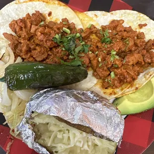 2 Pastor taco, baked potato with Jack cheese, avocado, grilled onions and jalapeño