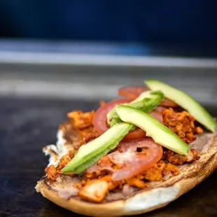 Tortas: beans, mayonnaise, Monterey Jack, avocado, tomatoes,grilled onions and the protein of your choice.