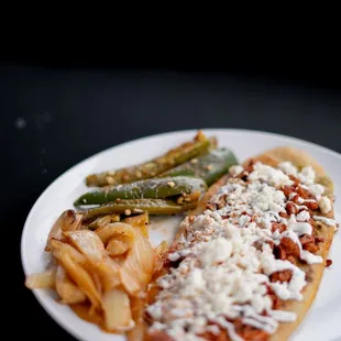 Huaraches: corn dough filled with beans, protein, sour cream and queso fresco