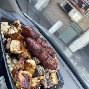 Rice and noodles underneath with chicken, beef, and shrimp with hot links! I paid extra for the hot links
