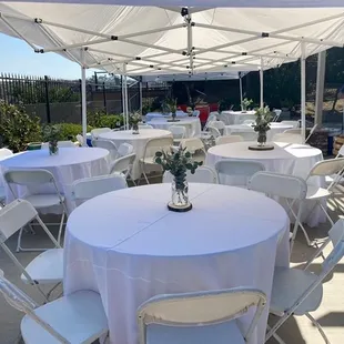 Round tables with beautiful white linens. Makes your event look extra elegant .