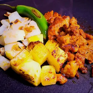 Grilling up some of our Al Pastor, with, grilled onions and pineapple.