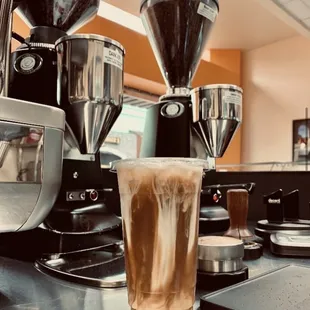 a glass of iced coffee on a counter