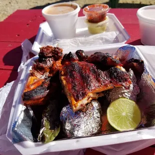 Half chicken with lime, grilled onions, chile sauces, and pepper