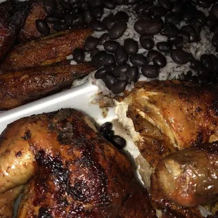 1/2 chicken with plantains and rice and beans.