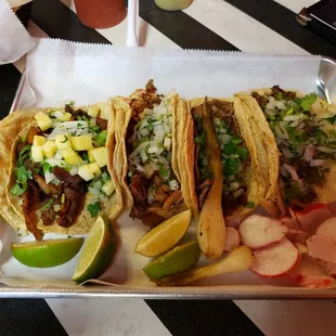 Left to right Takos de Pastor (pork), takos bravo (steak with sauteed onions and hot peppers) takos de lomo (ribeye), taco de asada (steak)
