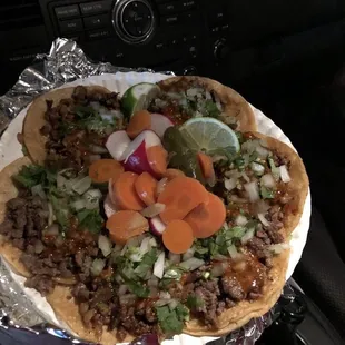 a hand holding a pizza