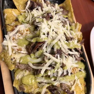 Green chilaquiles with two eggs and steak