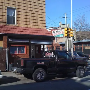 a black pickup truck parked in front of a restaurant