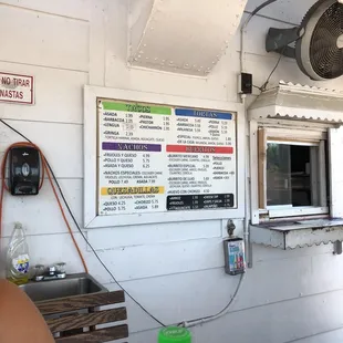 a menu on the wall of a restaurant