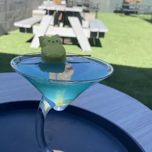 a green frog in a martini glass