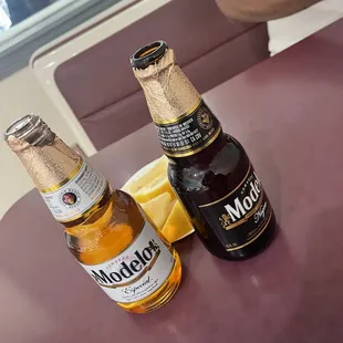 two bottles of beer on a table