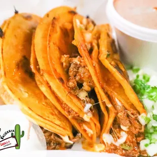 a plate of tacos with sauce