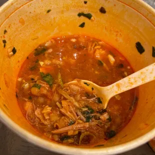 a bowl of soup with a wooden spoon
