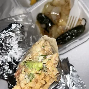 a burrito wrapped in aluminum foil