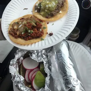 two tacos on a paper plate