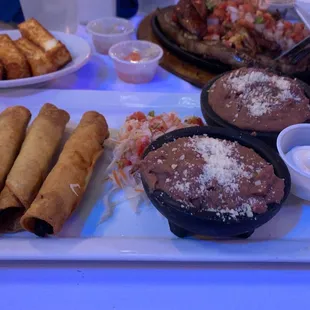 Chicken tacos, refried beans and queso frito