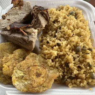 I loved my arroz con gandules w/ lechon asado &amp; tostones... ketchup-mayo sauce (not shown) was also yummy with the tostones