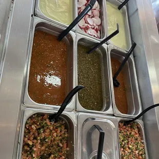 Salsa bar with creamed avocado, fresh pico de gallo and fresh salsas.