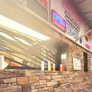 a restaurant with a stone wall