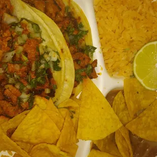 two tacos and chips on a plate