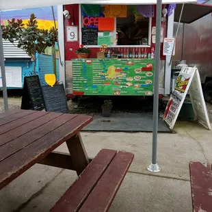 a picnic table and a food truck
