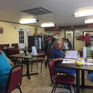people sitting at tables in a restaurant