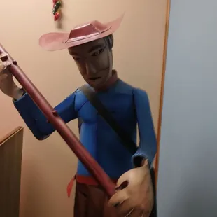 a figurine of a man in a cowboy hat