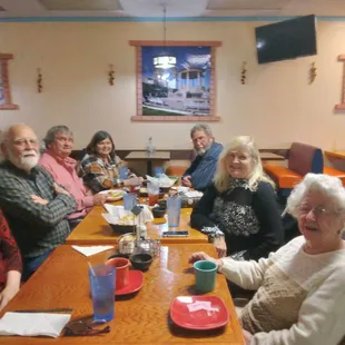 a group of people sitting at a table