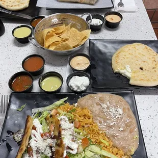 Crispy tacos and cheese pupusa, California burrito in the back.