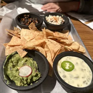 a tray of guacamole and chips